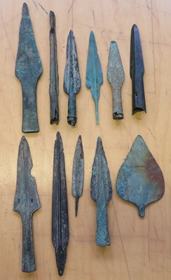 Lot 50 - â’¶ A WEST EUROPEAN BRONZE SPEARHEAD, 3000-1500 B.C. AND TEN FURTHER BRONZE WEAPONS