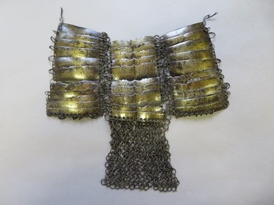 Lot 63 - â’¶ THE CENTRAL PORTION OF AN INDIAN MAIL AND LAMELLAR SHIRT, 17TH CENTURY