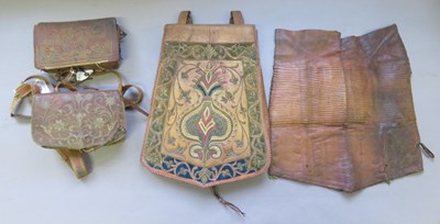 Lot 119 - A LARGE NORTH AFRICAN LEATHER SADDLE POUCH AND TWO SMALLER POUCHES