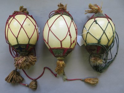 Lot 122 - THREE OSTRICH EGGS WITH NORTH AFRICAN DECORATED MOUNTS, ALGERIA OR MOROCCO
