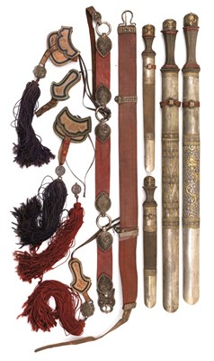 Lot 18 - A BHUTANESE SILVER-MOUNTED GARNITURE OF TWO SWORDS AND TWO DAGGERS