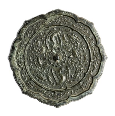 Lot 76 - A CHINESE LOBED BRONZE 'PHOENIX AND LOTUS' MIRROR, TANG DYNASTY (618-907)