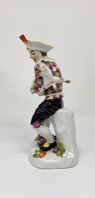 Lot 10 - A MEISSEN FIGURE OF HARLEQUIN PLAYING A PUG, 20TH CENTURY