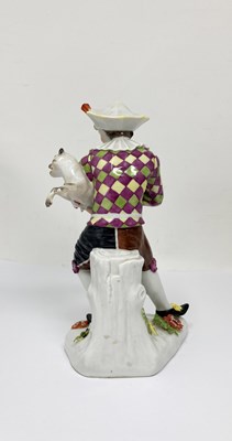 Lot 10 - A MEISSEN FIGURE OF HARLEQUIN PLAYING A PUG, 20TH CENTURY