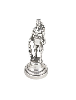 Lot 527 - A SMALL GEORGE V SILVER FIGURE OF AN AFRICAN RIFLEMAN