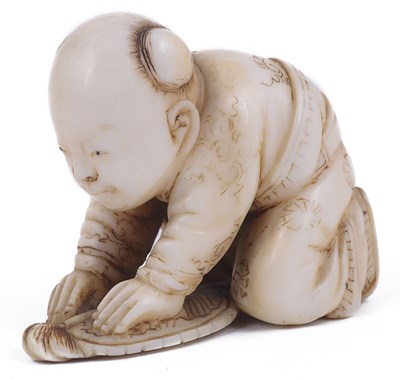 Lot 126 - ~LIGHTLY STAINED IVORY NETSUKE OF A BOY CRUSHING A BUTTERFLY WITH A FAN