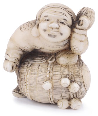 Lot 139 - ~WALRUS IVORY NETSUKE OF THE LUCKY GOD DAIKOKU WITH HIS RICE BALE