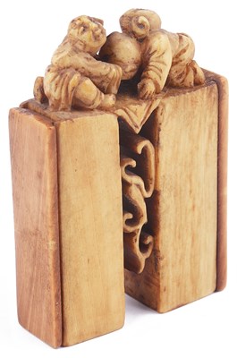 Lot 143 - ~STAINED IVORY SEAL CASE NETSUKE