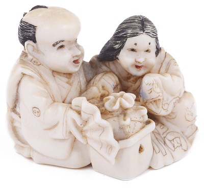 Lot 149 - ~PARTLY STAINED IVORY NETSUKE OF A MAN WITH OKAME