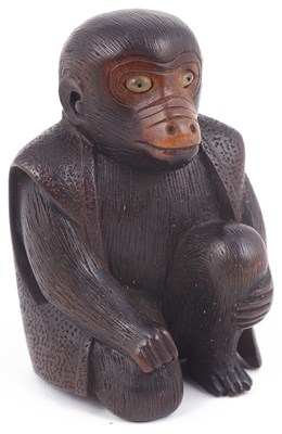 Lot 160 - WOOD NETSUKE OF A SEATED PERFORMING MONKEY