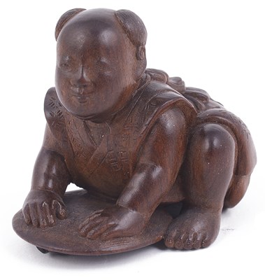 Lot 166 - WOOD NETSUKE OF A BOY CRUSHING A FIREFLY WITH A FAN