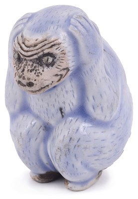 Lot 179 - BLUE AND WHITE PORCELAIN NETSUKE OF A MONKEY CLUTCHING ITS EARS