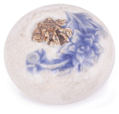 Lot 182 - PORCELAIN MANJU NETSUKE MOULDED WITH A SHISHI LION AND PEONY