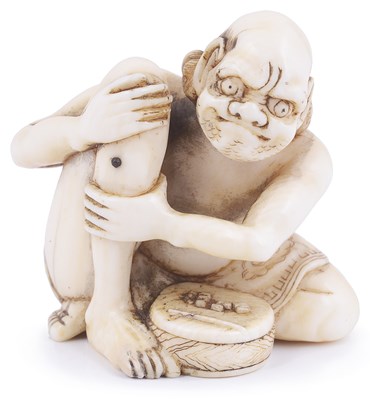 Lot 185 - ~IVORY NETSUKE OF A MAN APPLYING MOXA