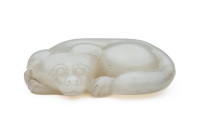 Lot 57 - A CHINESE CELADON-WHITE JADE DOG, QING DYNASTY (1644-1911)