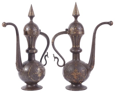 Lot 290 - â€¡A PAIR OF QAJAR GOLD DAMASCENED STEEL EWERS