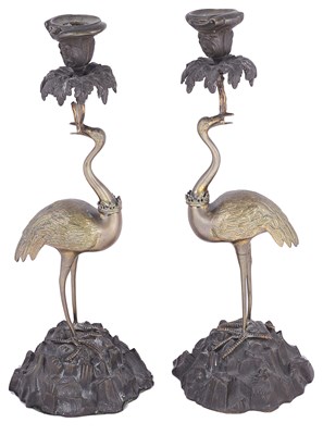 Lot 432 - A PAIR OF BRONZE AND BRASS 'STORK' CANDLESTICKS