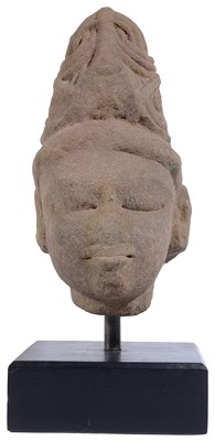 Lot 117 - A PINK SANDSTONE HEAD OF A DEITY