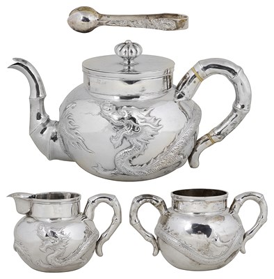 Lot 339 - ËœA BOXED CHINESE SILVER THREE-PIECE TEA SET AND SUGAR TONGS