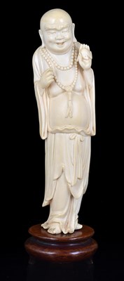 Lot 135 - A JAPANESE IVORY OKIMONO OF HOTEI