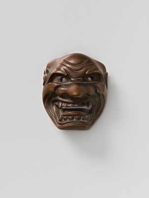 Lot 101 - A JAPANESE MASK NETSUKE OF SHISHIGUCHI