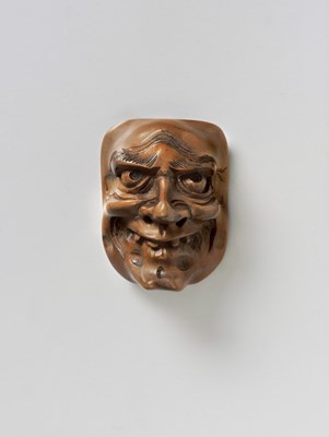 Lot 110 - A JAPANESE MASK NETSUKE OF SHISHIGUCHI
