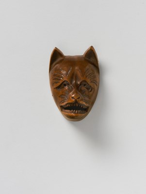 Lot 122 - A JAPANESE MASK NETSUKE OF KITSUNE