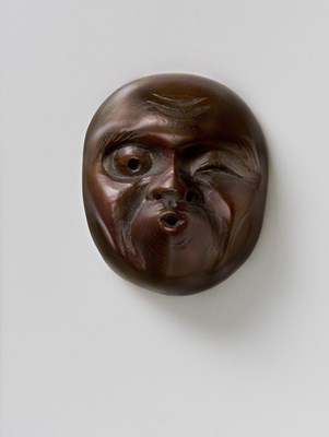 Lot 129 - A JAPANESE MASK NETSUKE OF USOBUKI