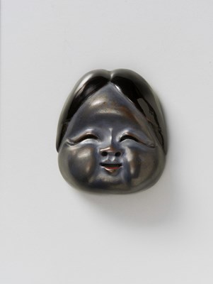 Lot 131 - A JAPANESE MASK NETSUKE OF OKAME