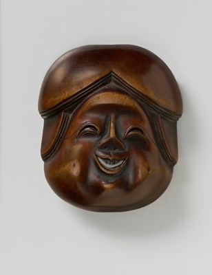 Lot 146 - A JAPANESE MASK NETSUKE OF OKAME