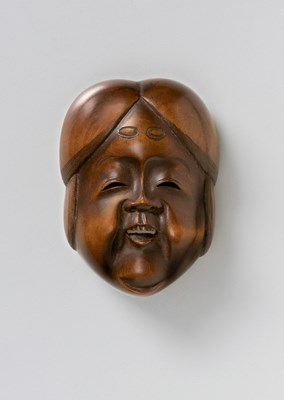 Lot 150 - A JAPANESE MASK NETSUKE OF OKAME