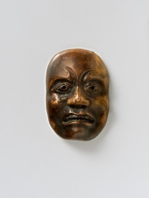 Lot 168 - A JAPANESE MASK NETSUKE OF A DOLEFUL MAN