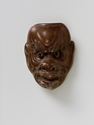 Lot 199 - A JAPANESE MASK NETSUKE OF A HIRSUTE DEMON