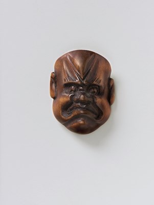 Lot 200 - A JAPANESE MASK NETSUKE OF A FROWNING MAN