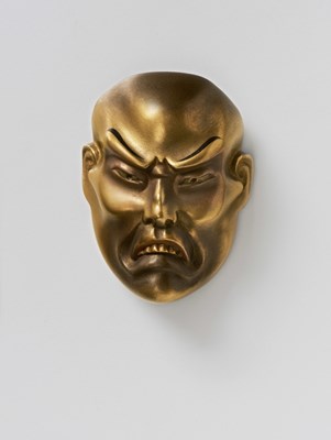 Lot 209 - A JAPANESE MASK NETSUKE OF A MOROSE MAN