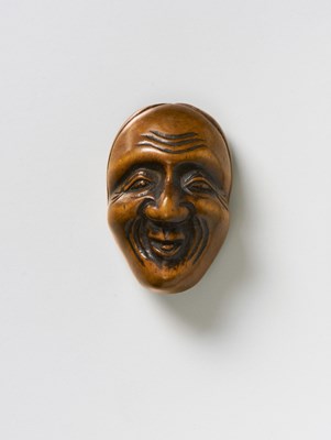 Lot 210 - A JAPANESE MASK NETSUKE OF A SMILING MAN