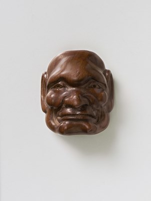 Lot 211 - A JAPANESE MASK NETSUKE OF A MOROSE MAN