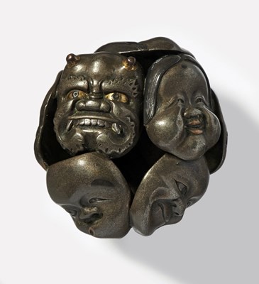 Lot 218 - A JAPANESE NETSUKE OF A CLUSTER OF MASKS