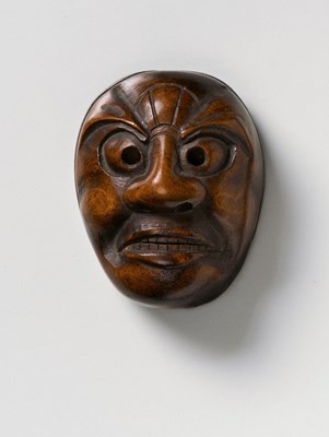 Lot 227 - A JAPANESE MASK NETSUKE OF A GRIMACING GHOUL