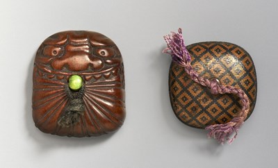 Lot 228 - A JAPANESE NETSUKE OF A MASK WRAPPED IN A CLOTH