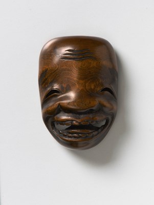 Lot 231 - A JAPANESE MASK NETSUKE OF A GRINNING MAN