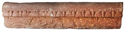 Lot 293 - A MOTTLED PINK SANDSTONE COPING STONE FRAGMENT