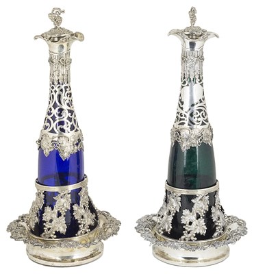 Lot 526 - A pair of German silver-mounted glass decanters on SILVER coasters