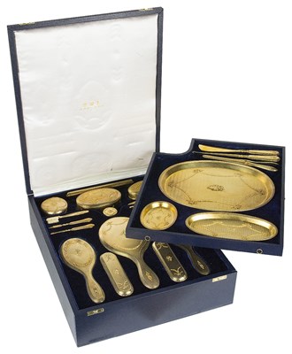Lot 574 - ~AN EDWARDIAN SILVER-GILT DRESSING TABLE SET