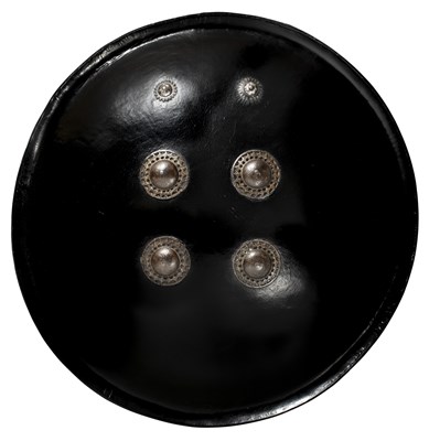 Lot 77 - AN INDIAN BLACK LACQUERED BUFFALO HIDE SHIELD (DHAL), 18TH/19TH CENTURY