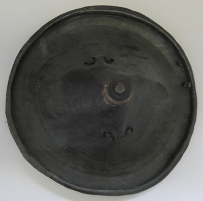 Lot 202 - A NORTH AFRICAN BLACKENED HIDE CIRCULAR SHIELD, LATE 19TH CENTURY