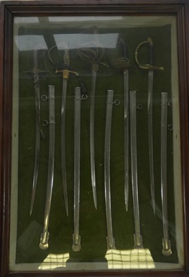Lot 284 - A GLAZED DISPLAY OF FIVE MINIATURE GERMAN MILITARY SWORDS
