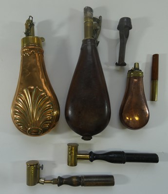 Lot 412 - AN EMBOSSED BRASS POWDER-FLASK; A COPPER PISTOL FLASK; A LEATHER SHOT-FLASK; TWO POWDER MEASURES AND