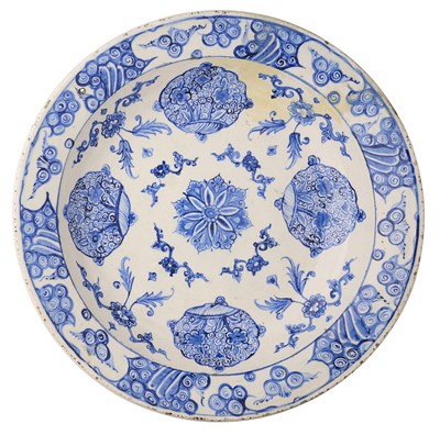 Lot 32 - AN IZNIK BLUE AND WHITE DISH, OTTOMAN ANATOLIA, CIRCA 1560-80