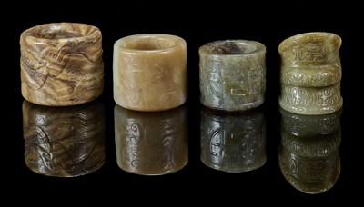 Lot 82 - FOUR CARVED JADE ARCHERS RINGS, QING DYNASTY, 19TH CENTURY